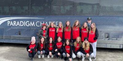 Travel in style with Paradigm Charter Bus - one of the top Bus companies in Saskatchewan with a happy group of passengers and a skilled driver.